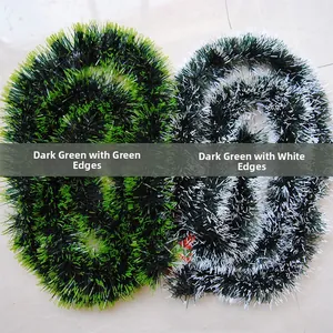 Detail showing dark green Christmas tinsel garlands with green and white tips and bows