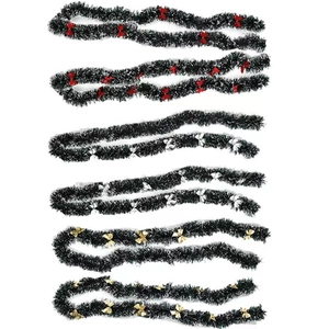 Dark green Christmas tinsel garland set with red gold and silver bows for holiday decor