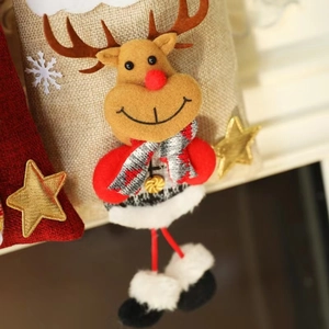 Close-up of a 3D plush Christmas reindeer gift bag with plaid scarf and golden star detail