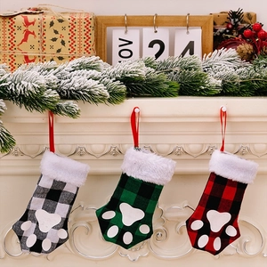 Three-pack plaid pet paw Christmas stockings in red, green, and black with faux fur trim