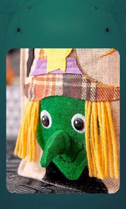 Detail of burlap Halloween bag featuring a green witch with 3D yarn hair and stitching