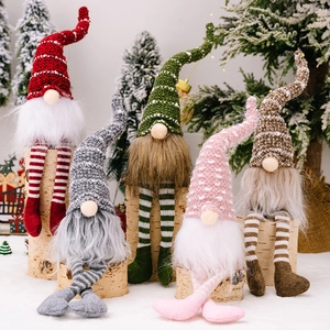 Set of 5 Christmas gnomes with striped hats and long legs on rustic wood display