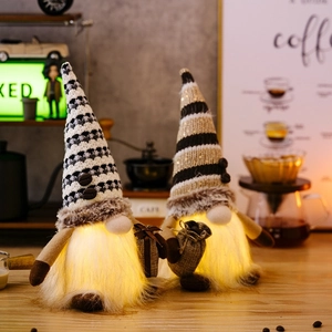 Detail of LED lighted coffee gnomes with striped knit hats and glowing plush bellies