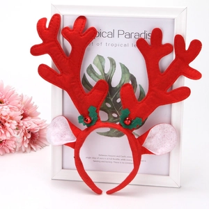 Christmas reindeer antler headband with red plush fur, green holly leaves, and bells