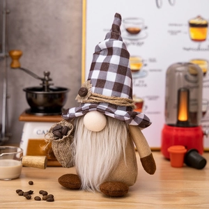 Detail view of coffee gnome plush with black checkered hat and mini coffee bean bag