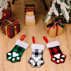 Three-piece buffalo plaid pet paw Christmas stockings with faux fur trim for holiday hanging