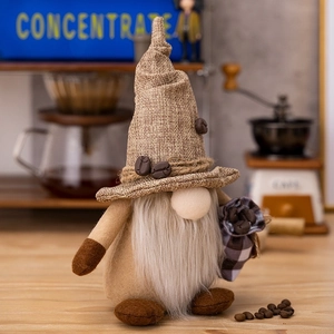 Detail of coffee gnome plush with burlap hat and small plaid bag filled with coffee beans