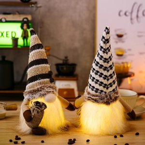 Close-up of LED glowing coffee gnomes with knitted hats and miniature coffee bean bags