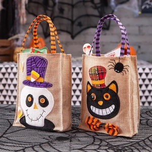 Halloween burlap gift bags with skull and black cat designs for party decorations