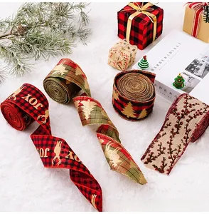 Close-up of four assorted Christmas burlap ribbons with festive JOY and deer patterns