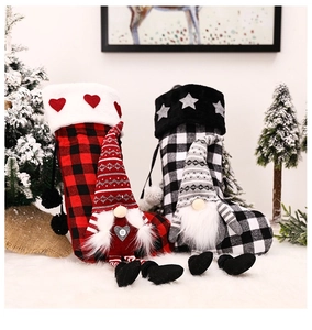 Detail of red and black buffalo plaid Christmas stockings with gnome plush decor