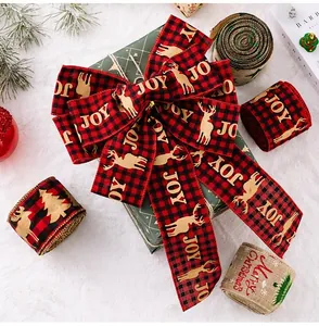 Close-up of burlap Christmas ribbons with Joy and Merry Christmas prints on faux fur