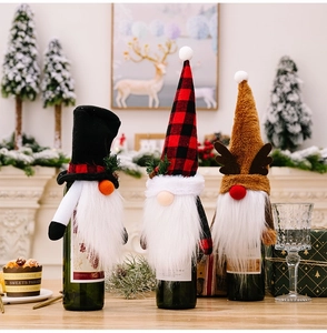 Detailed view of three festive gnome wine bottle covers with plush beards and reindeer antlers