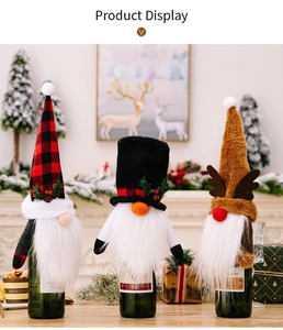 Detailed close-up of three Christmas gnome wine bottle covers with knitted holiday decor