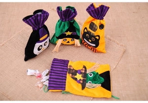 Set of four Halloween velvet drawstring gift bags with cartoon skull and witch designs
