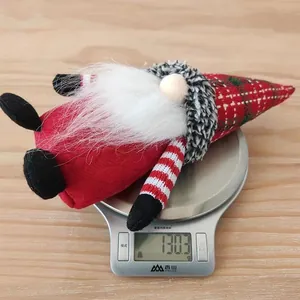 Detail showing Christmas gnome plush weighing approximately 130.3g on a scale