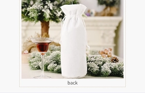 Close-up of a white drawstring wine bottle gift bag with elegant snowflake bead details
