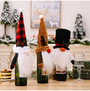 Detail view of festive Christmas gnome wine bottle covers with flannel texture and plush beard
