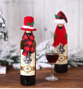 Festive red and black plaid Christmas hat and scarf set decorating a wine bottle