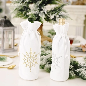 White plush Christmas wine bottle bags with silver and gold sequin snowflake designs