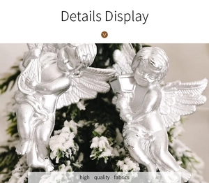 Close-up of silver angel hanging ornaments with feathered wings for Christmas tree decor