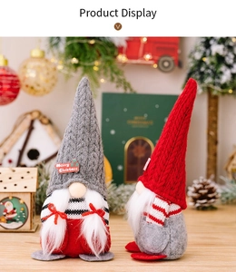 Close-up of knit Christmas gnomes with Merry Christmas sign on a festive background