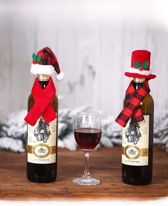 Detail showing mini Christmas hats and scarves with holly berries on wine bottles