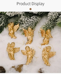 Detailed view of six golden Christmas angel ornaments with instruments on snow