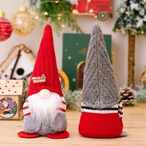 Detail of red and grey knitted Christmas gnomes with Merry Christmas badge and white beard