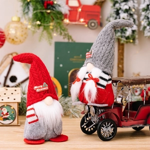 Christmas gnomes figurines with knitted hats and Merry Christmas embroidery for holiday decor