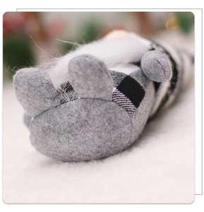 Detailed view of Christmas gnome plush with black and white plaid and soft white faux fur beard
