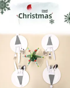 Mini gray Christmas hat cutlery holder set on plates for festive holiday dining decor