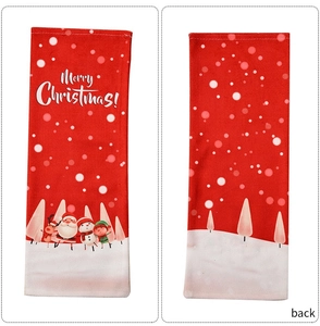 Detailed view of red Christmas wine bottle covers with Santa and reindeer cartoon prints