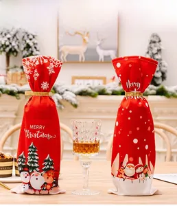 Detail of red Christmas wine bottle covers with Santa motifs and Merry Christmas text