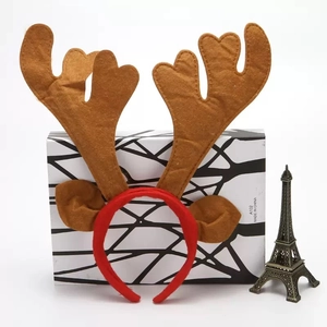 Detailed close-up of Christmas reindeer antler headband with brown felt ears and red fabric
