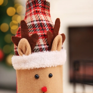 Close-up of reindeer wine bottle cover with red plush nose and plaid fabric details
