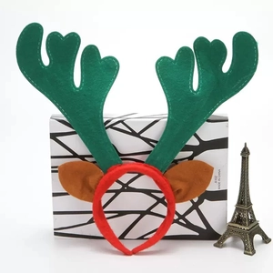Detail of Christmas reindeer antler headband with brown ears and red fabric base