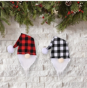 Close-up of red and black plaid Christmas gnome hanging ornaments with white faux fur beards