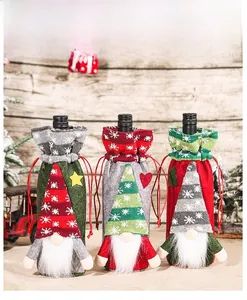Close-up of three knitted Christmas wine bottle covers with forest gnome designs