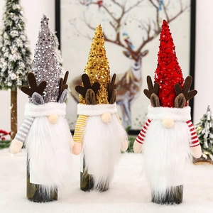 Three sequined Christmas gnome wine bottle covers with reindeer antlers for festive decor