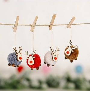 Set of four felt and wood reindeer ornaments hanging on twine for Christmas decor