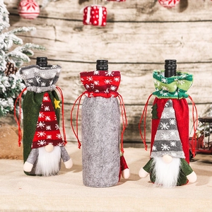 Three festive Christmas gnome wine bottle covers with drawstrings for holiday table decor