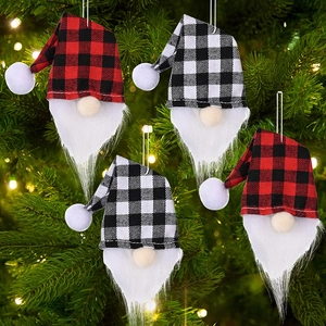 Set of 4 Christmas gnome ornaments with red and white buffalo plaid hats on a tree