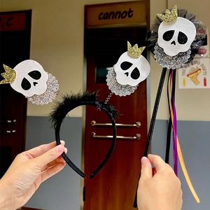 Halloween headband and wand set with glittery crowned skulls and black feathers