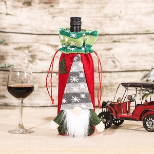 Christmas gnome wine bottle cover with red felt body and knitted grey hat for table decor