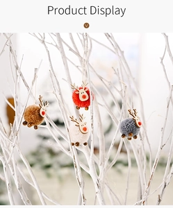 Close-up of four colored felt reindeer ornaments with pom-poms on white branches