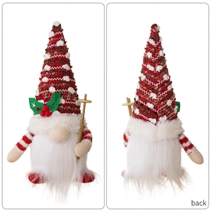 Front and back detail of a knitted Christmas gnome doll with a wooden cane and holly leaves