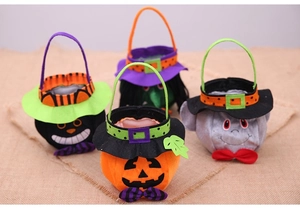 Detail view of four Halloween felt treat bags featuring pumpkin, cat and witch designs