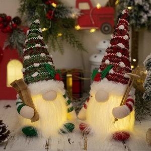 Close-up of lighted Christmas gnomes with ski gear and warm LED glow in holiday setting