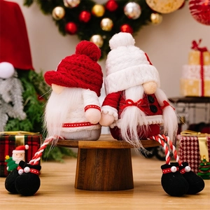 Close-up of knit Christmas faceless gnomes with long legs and cozy holiday decorations